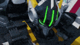a close up of a robot 's head with a green light coming out of it