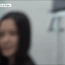 a blurry picture of a woman 's face with the words d-9 cam below it
