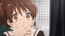a girl is covering her mouth with her hand and has the letter c on her forehead