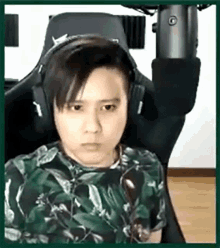 a young man wearing headphones is sitting in a chair .