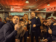 a group of people standing in front of a sign that says liquor locker