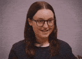 a woman wearing glasses and a black shirt