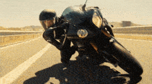 a man is riding a motorcycle down a highway
