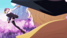 a man in a black hat looks at a woman in a red dress