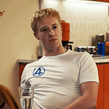 a man wearing a white t-shirt with the number four on it