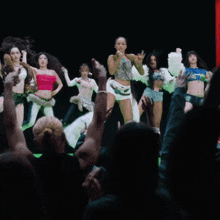 a group of women are dancing in front of a sign that says ep