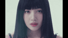 a close up of a woman 's face with black hair