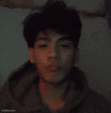 a close up of a young man 's face with a blurry background