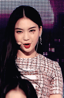 a close up of a woman 's face with a microphone in front of her
