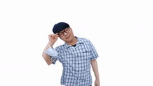 a man wearing glasses and a mask holds his hand to his head