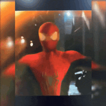 a blurry picture of a man in a spiderman costume