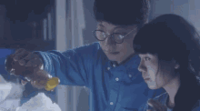 a man pouring honey into a woman 's mouth