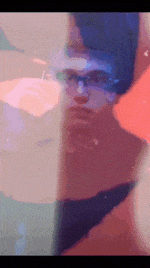 a pixelated image of a man with glasses looking at something