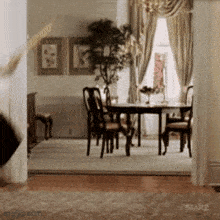a dining room with a table and chairs in it