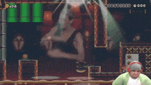 a man wearing headphones playing a video game with a woman in the background