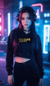 a woman wearing headphones and a crop top is standing in a neon room .
