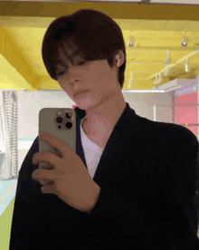 a young man is taking a selfie with his cell phone