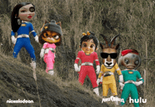 a group of power rangers dolls are standing on a hill