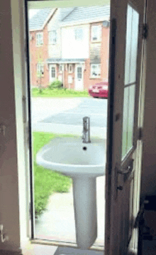 a sink is sitting outside of a doorway .