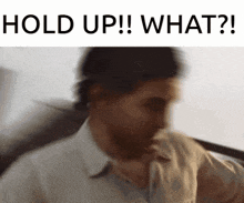 a blurry picture of a man with the words hold up what on the bottom