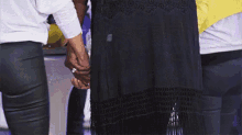 a group of women are holding hands in a circle .