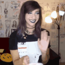 a woman with purple hair wearing a black t-shirt that says twenty on it