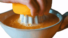 juicing orange two plaid aprons squeezing orange extracting orange juice preparing food