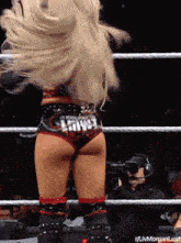 a woman in a wrestling ring with a belt that says liv morgan lust on it