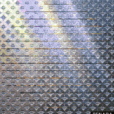 a wall with a geometric pattern and the word tenada on the bottom right