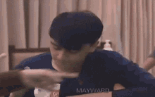 a blurry photo of a man with the name mayward on his shirt