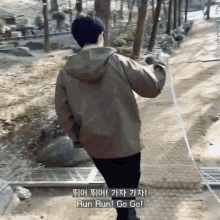 a man walking a dog on a leash with the words run run go go