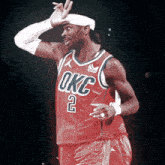 a basketball player in a red okc jersey