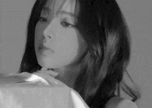 a black and white photo of a woman with a white shirt on
