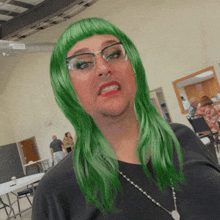 a man with green hair and glasses makes a face
