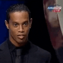 a man in a suit and tie is speaking on eurosport live