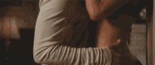 a man and a woman are hugging each other on a couch .