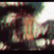 a blurry image of a person 's face with a purple and green background .