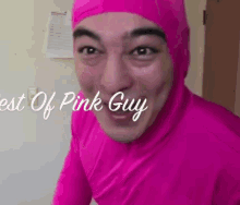 a man in a pink suit is making a funny face and smiling .