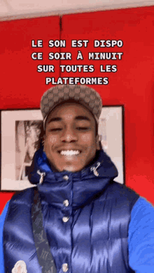 a man wearing a blue vest and a hat is smiling