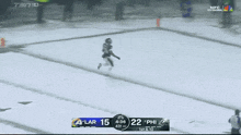 a football game is being played on a snowy field and the score is 15 to 22