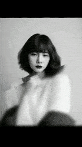 a black and white photo of a woman with short hair and red lipstick