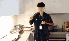 a man in a kitchen with a lanyard around his neck that says n on it