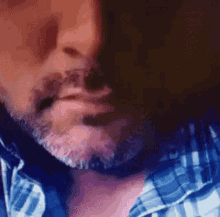 a man with a beard wearing a plaid shirt