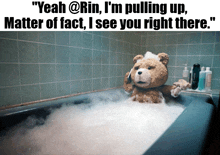 a teddy bear is taking a bath in a bathtub