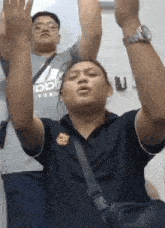 a man with his arms in the air is wearing a shirt that says adidas