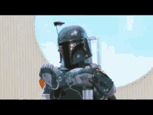 boba fett is wearing a green helmet and holding a gun