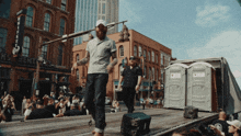 a man is walking in front of a building that has the word whiskey on it