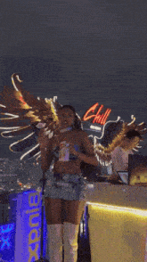 a woman with wings is dancing in front of a sign that says chill