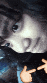 a close up of a person 's face with a thumbs up sticker