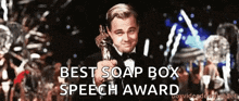 a man in a tuxedo holding an oscar statue with the words best soap box speech award below him